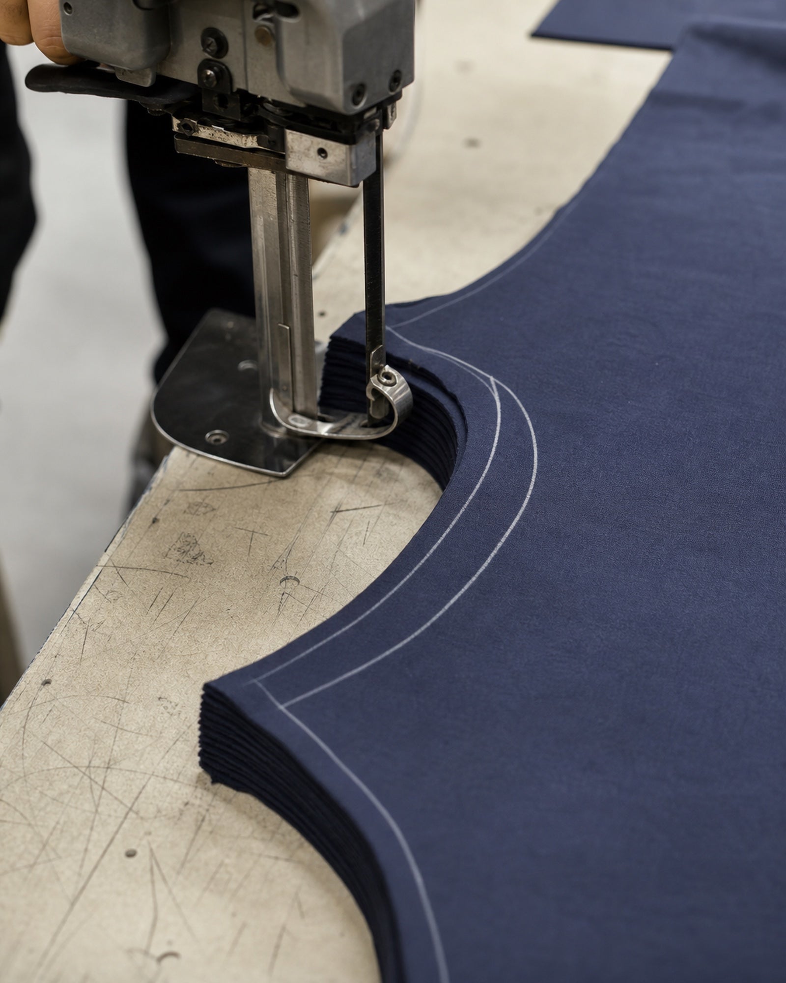 Close-up of curved cotton fabric panels being cut for T-shirt construction