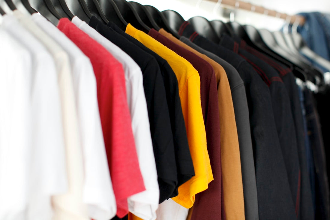 t-shirt sizing guide for clothing brands — neatly folded t-shirts in multiple sizes