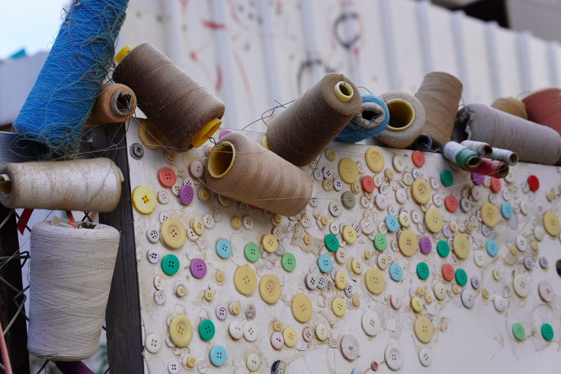 avoid clothing factory scam red flags — spools of thread hanging on a tailor workshop wall