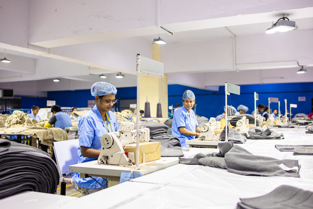 clothing manufacturing timeline — workers sewing clothes in a garment factory production line