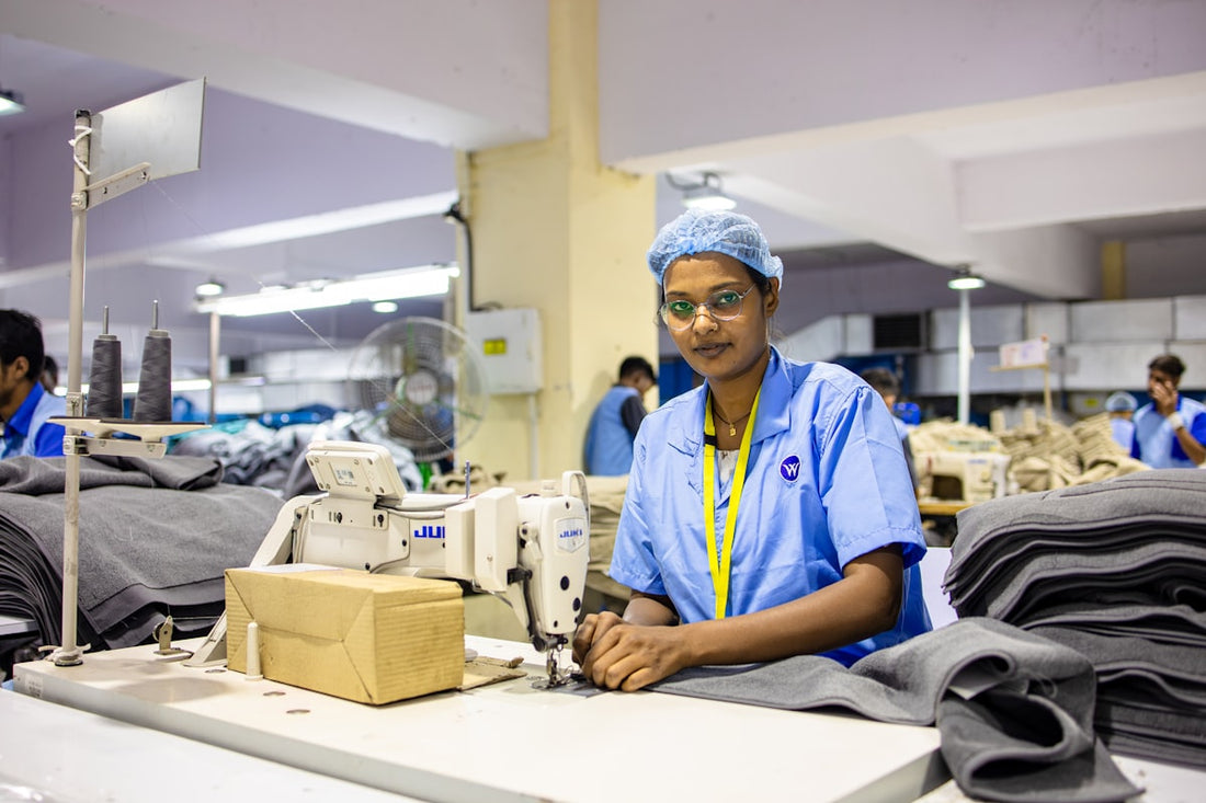 why manufacturers ghost clothing brands — woman sewing clothes in a garment factory
