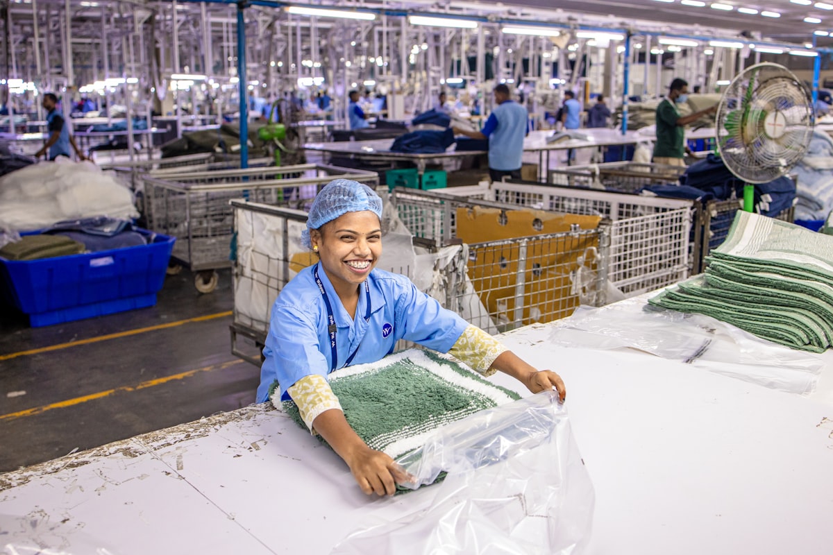 China vs Pakistan vs Portugal clothing manufacturing — woman working in clothing production facility