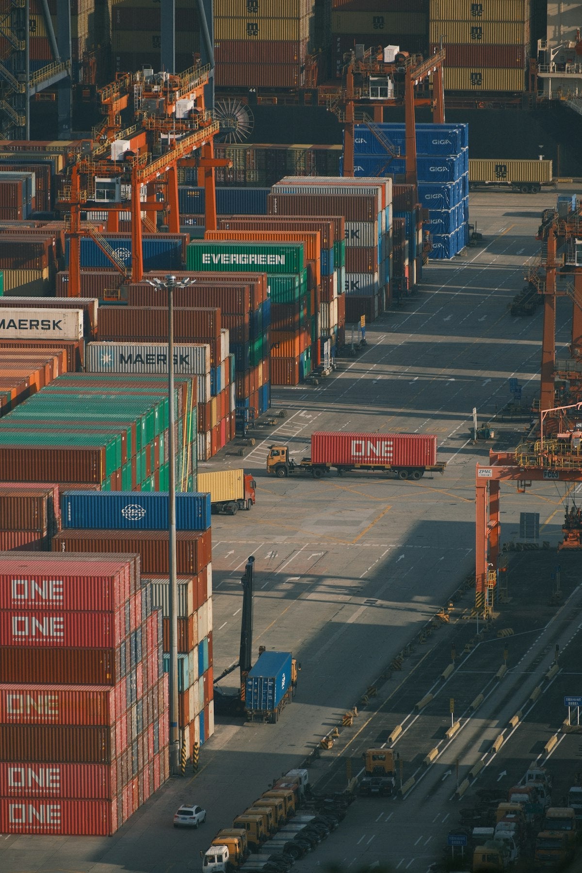 OEM vs ODM clothing manufacturing — shipping containers stacked at a busy freight port